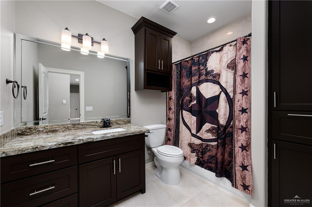 8405 Summer View Court Harlingen, TX 78552 - Photo 28 of 45 a bathroom with a toilet sink and mirror