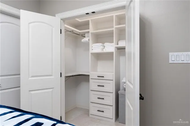 a view of walk in closet with empty racks