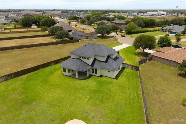 an aerial view of residential houses with outdoor space and swimming pool