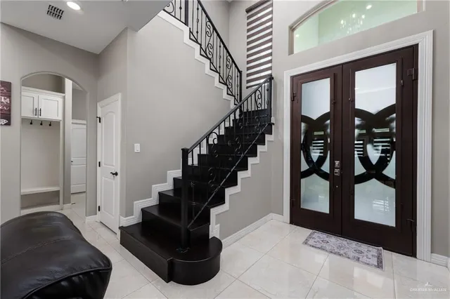 a living room with furniture and a floor to ceiling window
