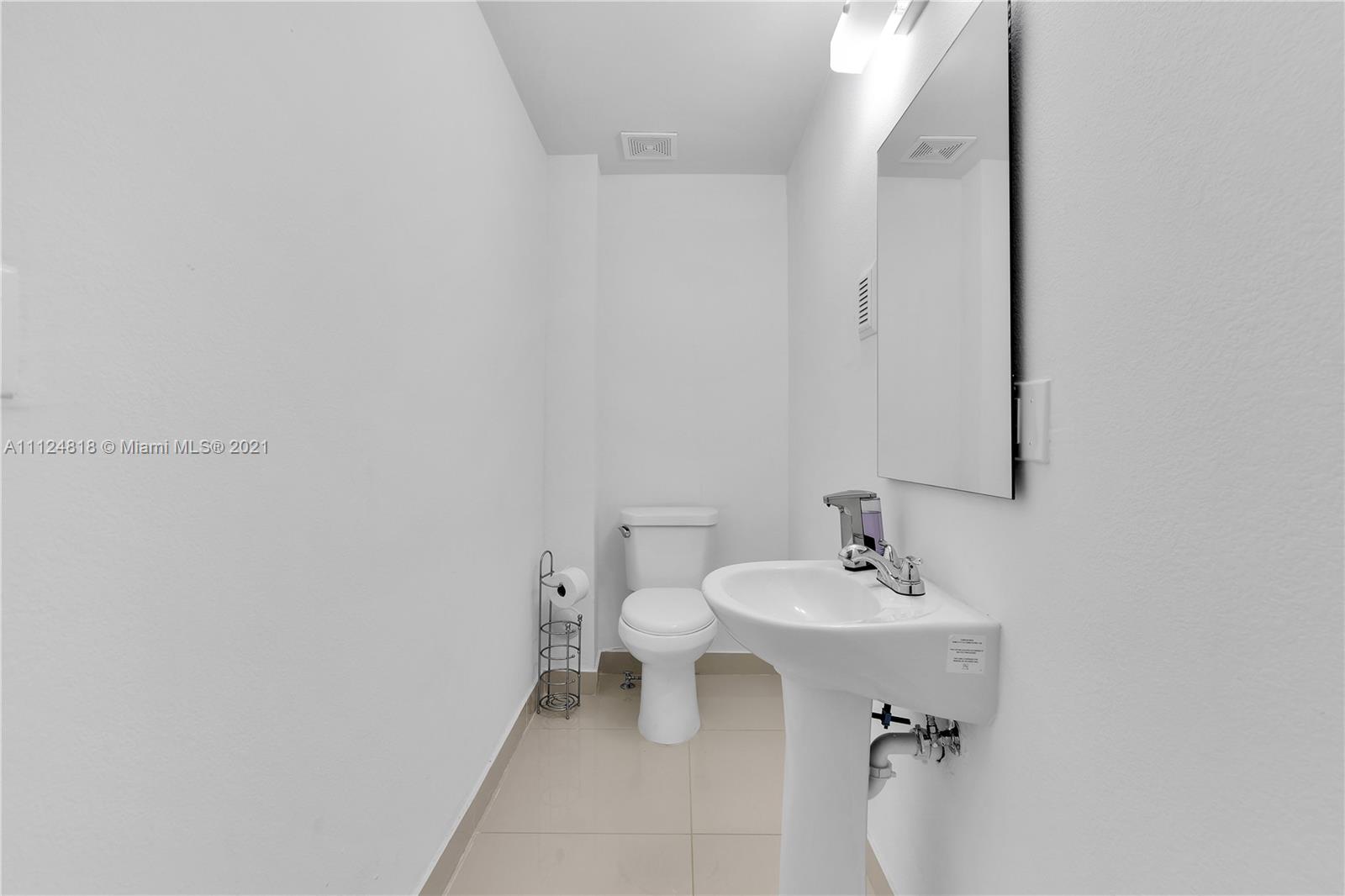 25807 Southwest 139th Court Homestead, FL 33032 - Photo 16 of 32 a bathroom with a sink a toilet and mirror