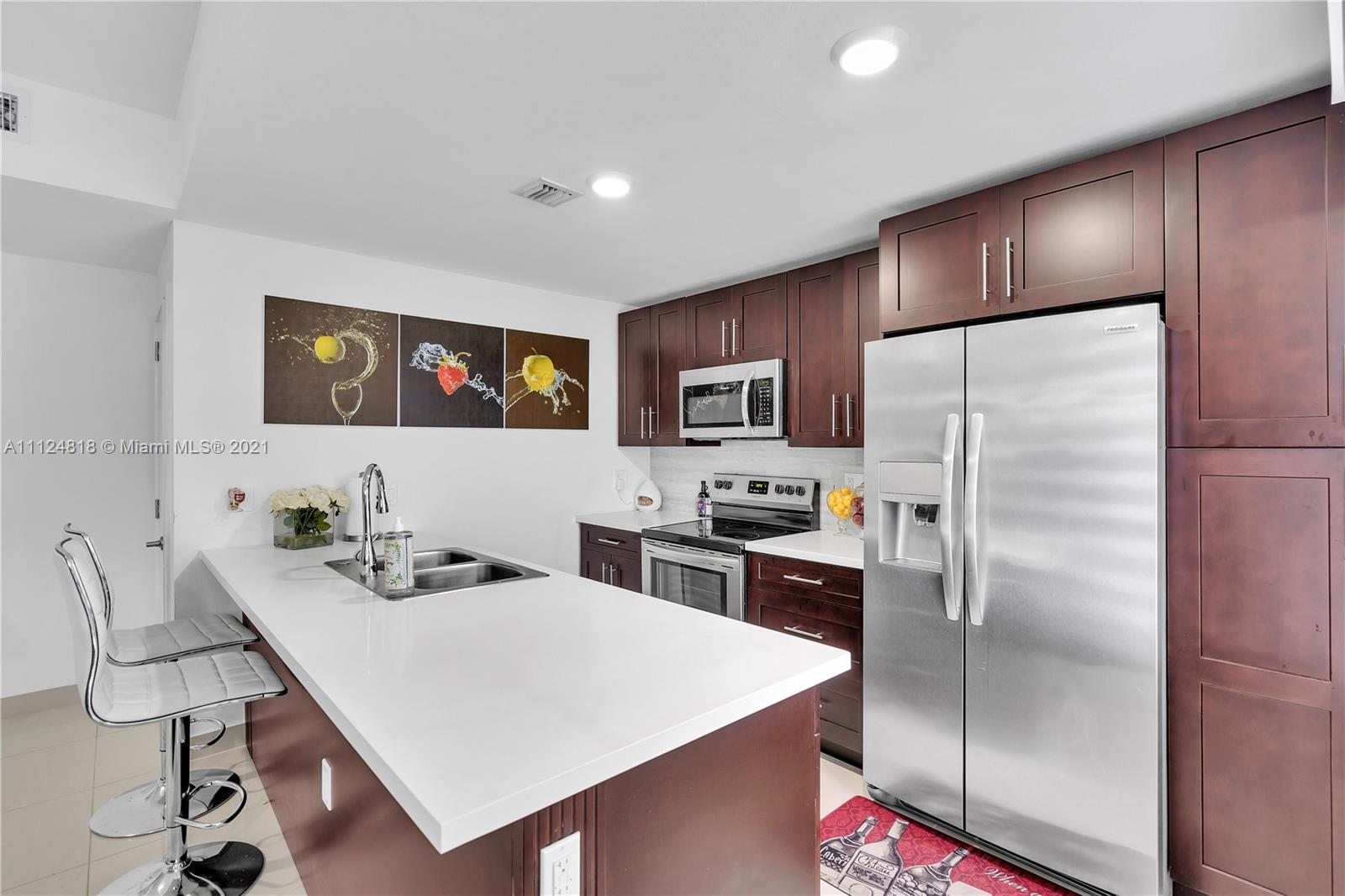 25807 Southwest 139th Court Homestead, FL 33032 - Photo 17 of 32 a kitchen with stainless steel appliances a refrigerator and a stove top oven
