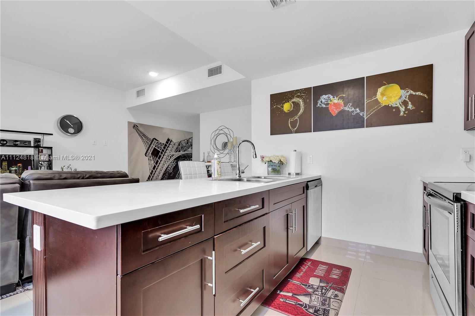 25807 Southwest 139th Court Homestead, FL 33032 - Photo 18 of 32 a kitchen with a sink and a stove with wooden floor