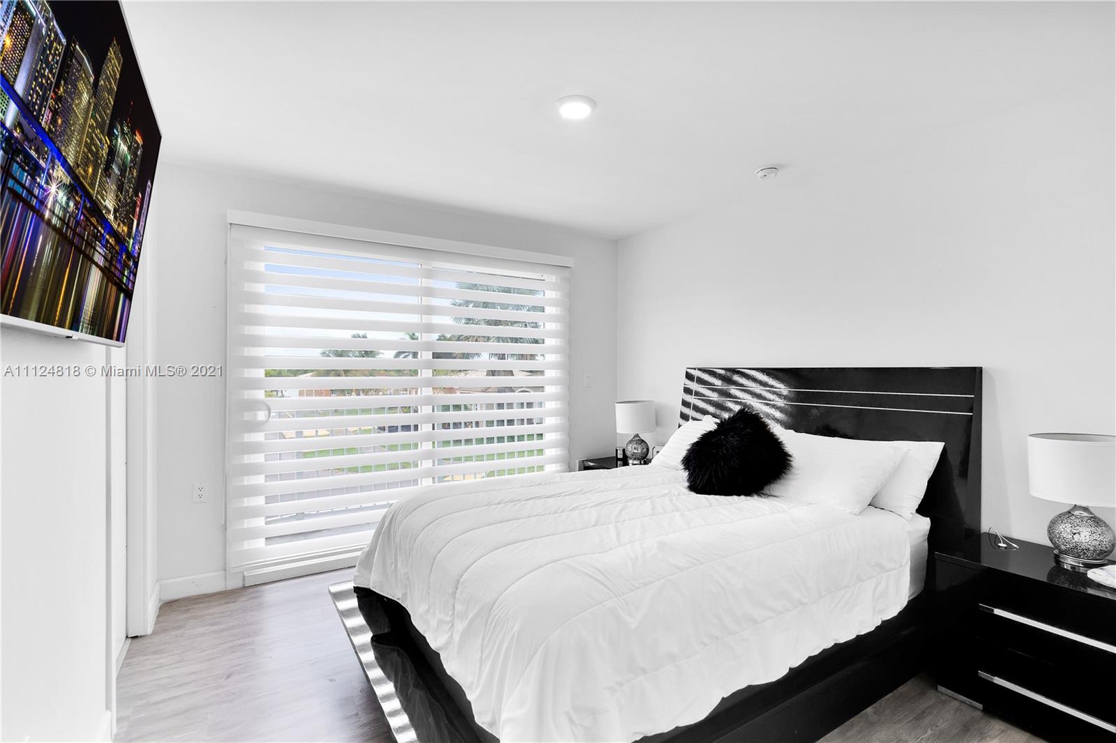 25807 Southwest 139th Court Homestead, FL 33032 - Photo 27 of 32 a bedroom with a bed and a large window