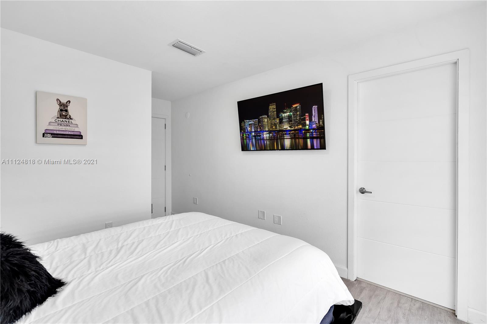 25807 Southwest 139th Court Homestead, FL 33032 - Photo 28 of 32 a bedroom with bed and wall painting
