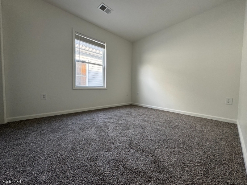121 12th Avenue Paterson, NJ 07501 - Photo 12 of 14 an empty room with a window