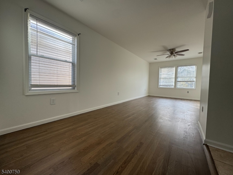 121 12th Avenue Paterson, NJ 07501 - Photo 4 of 14 a view of an empty room with wooden floor and a window