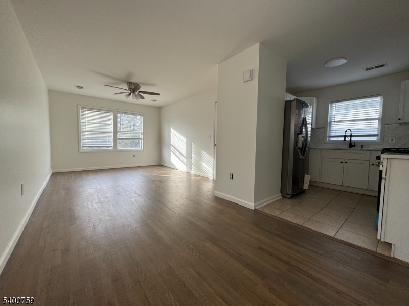 121 12th Avenue Paterson, NJ 07501 - Photo 5 of 14 an empty room with wooden floor and windows