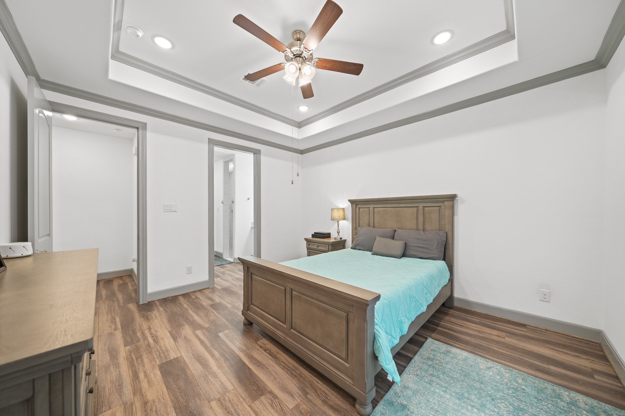 5739 Bobwhite Trail Manvel, TX 77578 - Photo 14 of 29 The spacious primary suite provides a peaceful retreat with elegant tray ceilings and a thoughtfully designed layout. Direct access to the ensuite bath enhances both comfort and convenience.