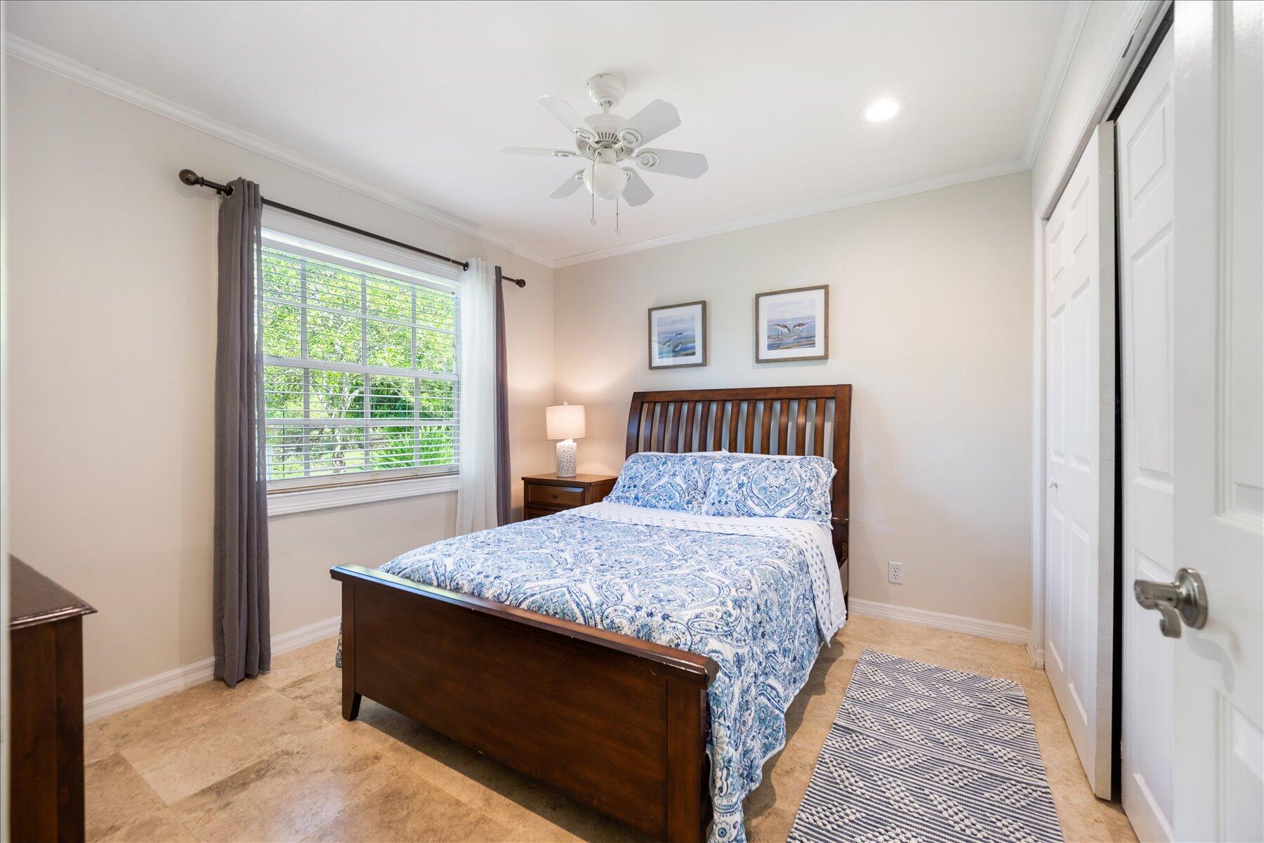 13889 Geranium Place Wellington, FL 33414 - Photo 17 of 32 a bedroom with a bed and a chandelier