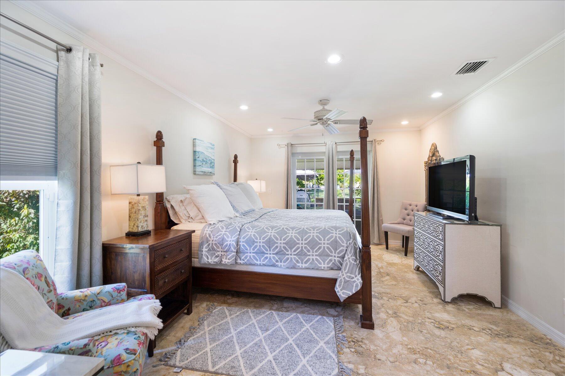 13889 Geranium Place Wellington, FL 33414 - Photo 23 of 32 a bedroom with a bed and flat screen tv