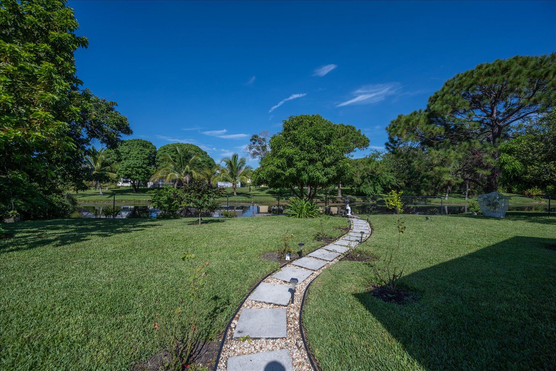 13889 Geranium Place Wellington, FL 33414 - Photo 30 of 32 a view of a park with large trees