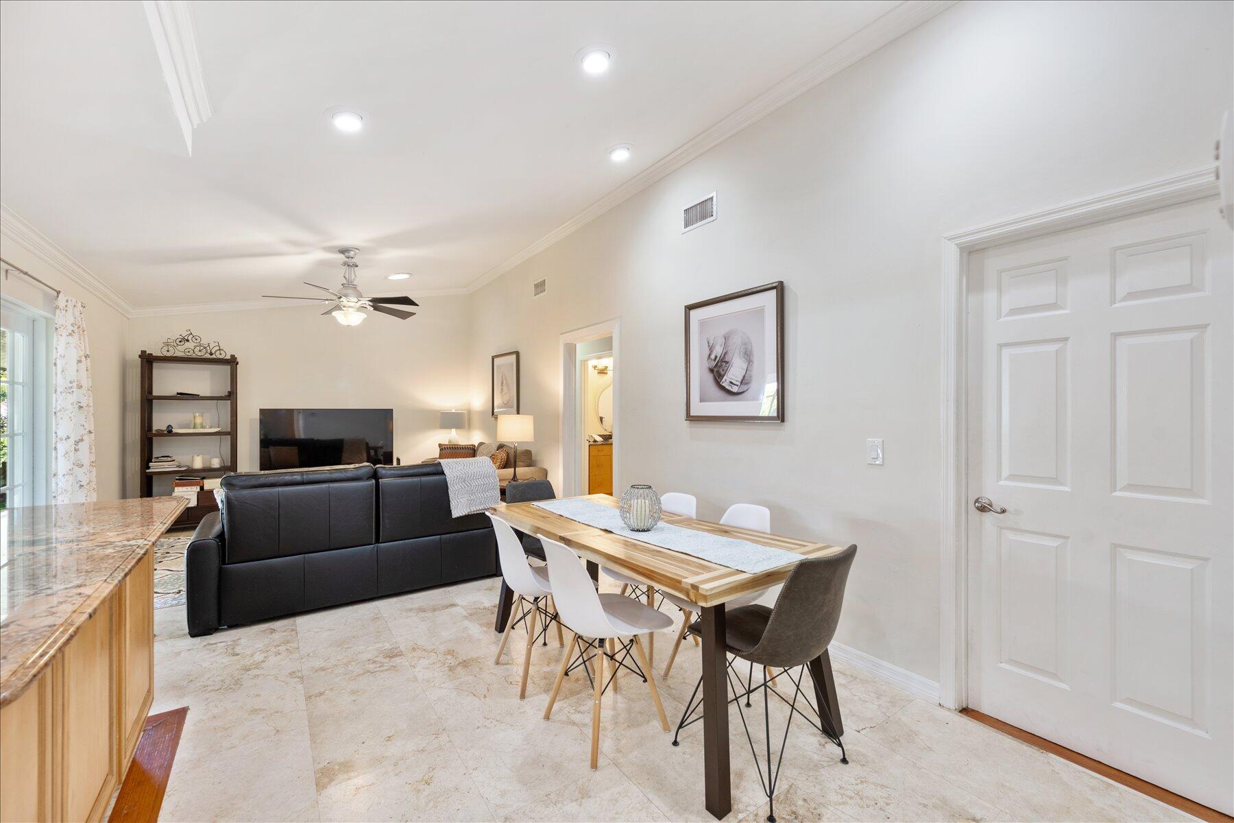 13889 Geranium Place Wellington, FL 33414 - Photo 8 of 32 a view of a dining room with furniture and wooden floor