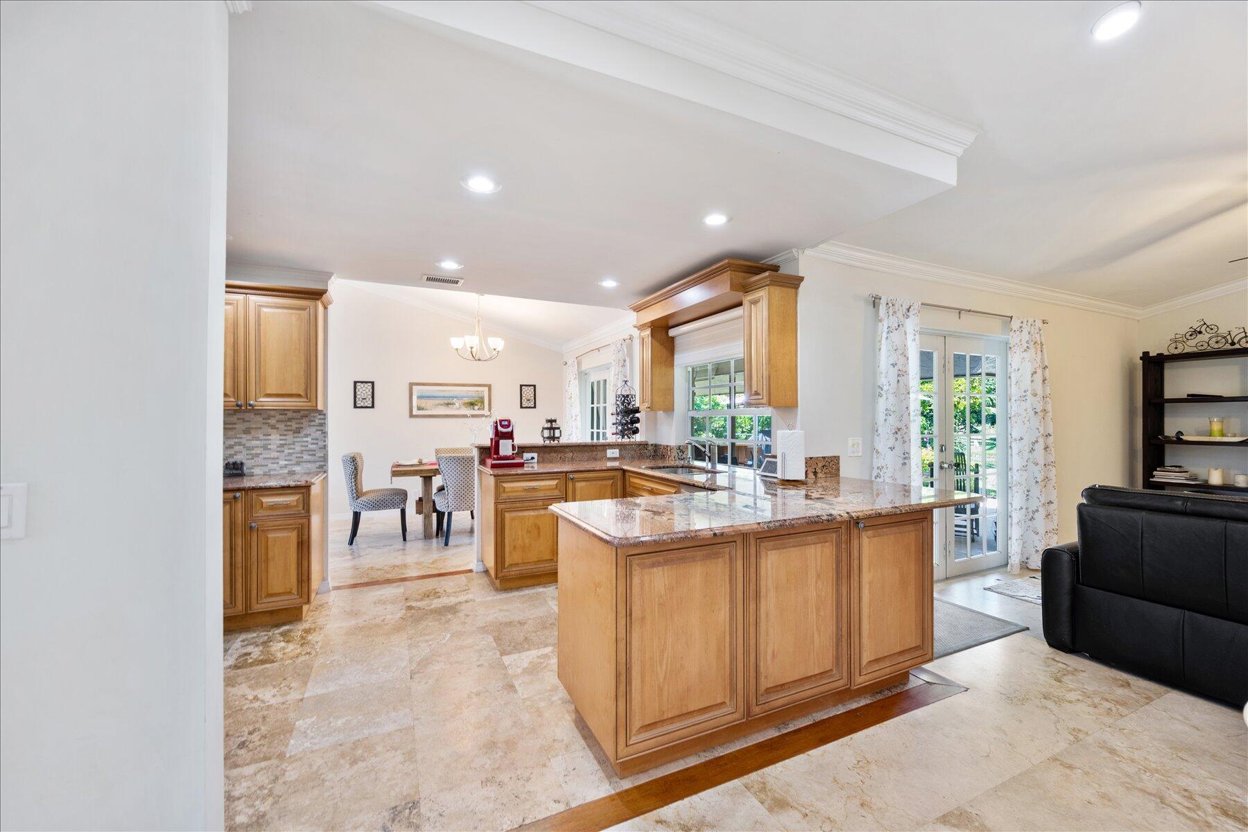 13889 Geranium Place Wellington, FL 33414 - Photo 9 of 32 a kitchen with lots of counter top space and living room