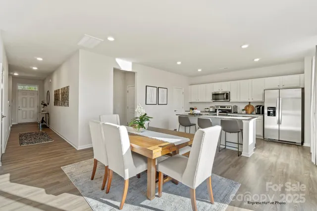 a kitchen with kitchen island white cabinets and stainless steel appliances