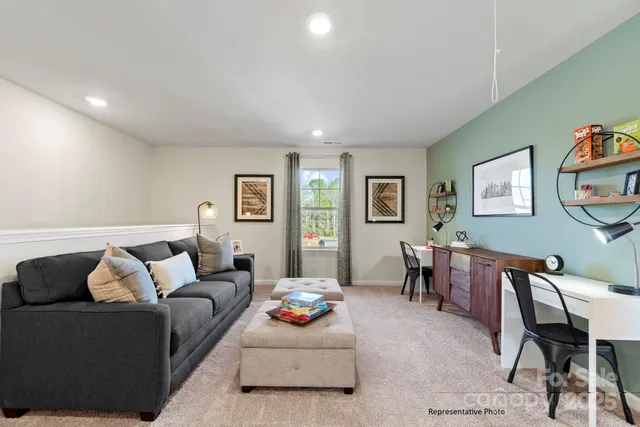a living room with furniture and a dining table with bookshelf
