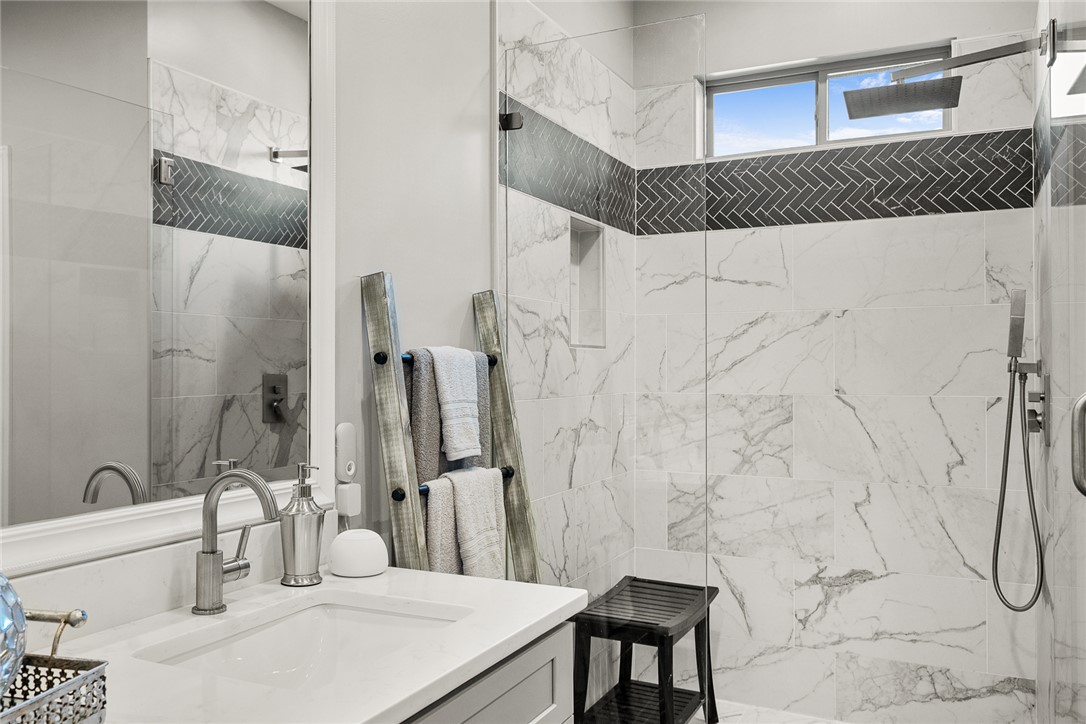 140 Turnberry Road Anderson, SC 29621 - Photo 18 of 44 This primary bathroom features a sleek vanity and a spacious, glass-enclosed shower with contemporary tiling.