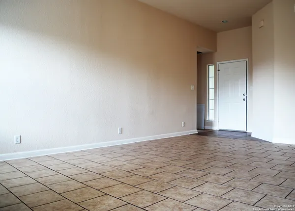 a view of an empty room and wooden floor