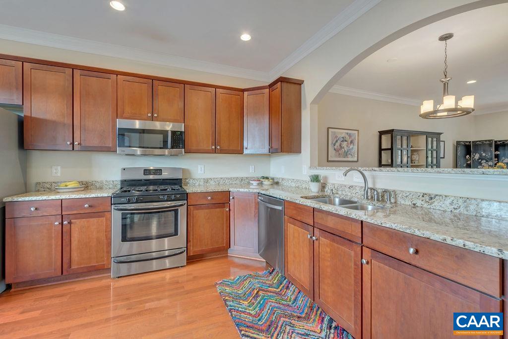 329 Quarry Road Charlottesville, VA 22902 - Photo 12 of 45 a kitchen with kitchen island granite countertop a sink cabinets and stainless steel appliances