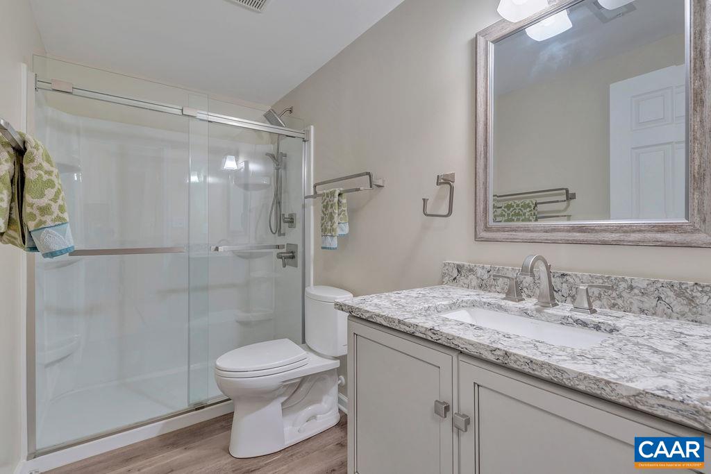 329 Quarry Road Charlottesville, VA 22902 - Photo 33 of 45 a bathroom with a granite countertop sink toilet a mirror and shower
