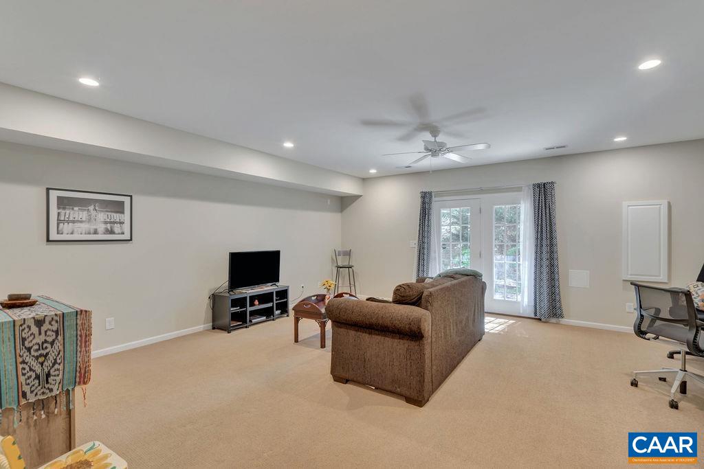 329 Quarry Road Charlottesville, VA 22902 - Photo 35 of 45 a living room with furniture and a flat screen tv