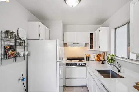a kitchen with a refrigerator and a sink