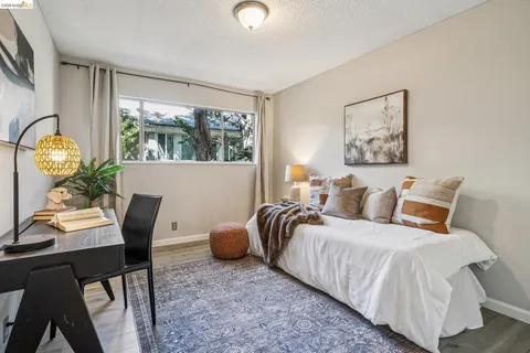 a bedroom with bed and a window