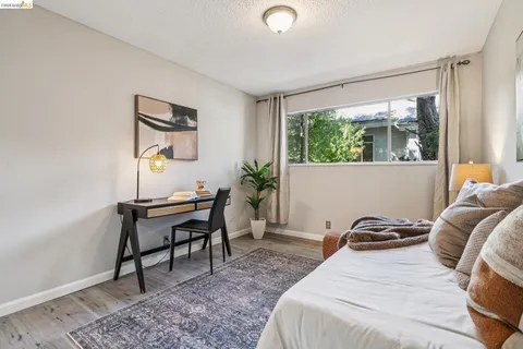 a bedroom that has a bed and a desk in it