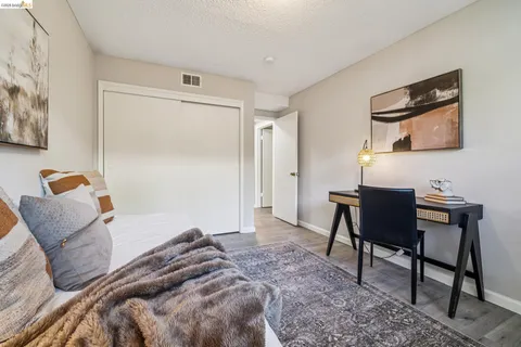 a bedroom with a bed and a chair