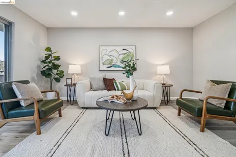 a living room with furniture and a potted plant