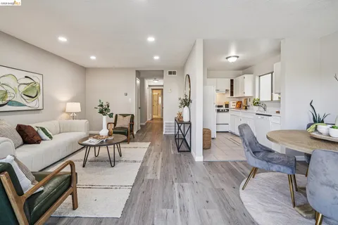 a living room with lots of furniture and wooden floor
