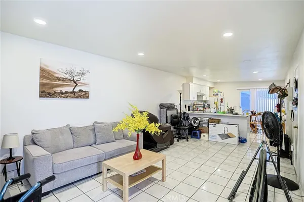 a living room with furniture a dining table and a painting on the wall