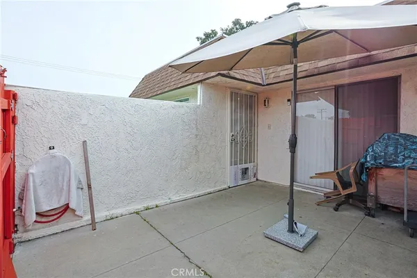 a backyard of a house with plants and wooden fence