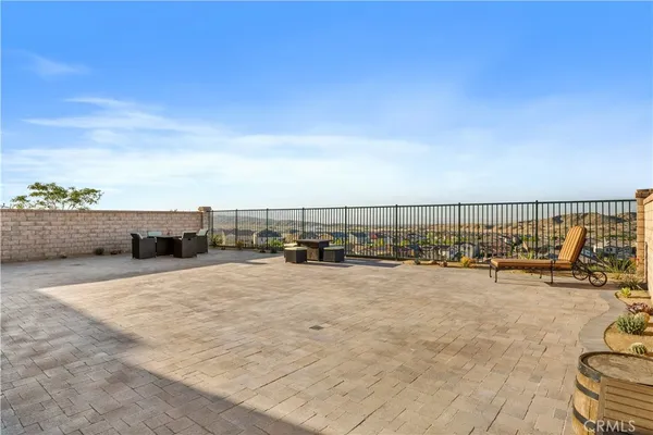 a view of swimming pool with lawn chairs