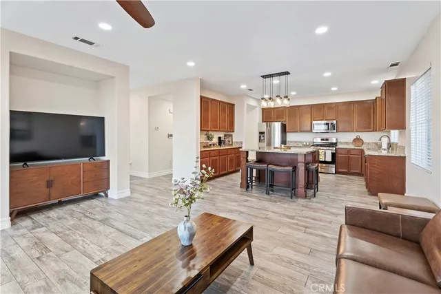 a living room with lots of furniture and kitchen view