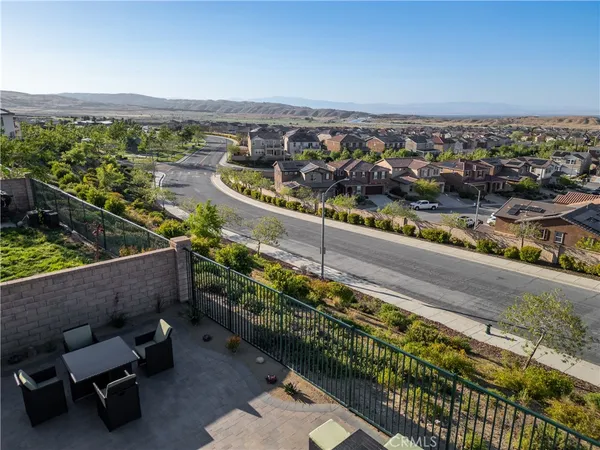 a city view from a balcony with two chairs