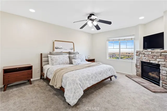 a spacious bedroom with a bed and a television