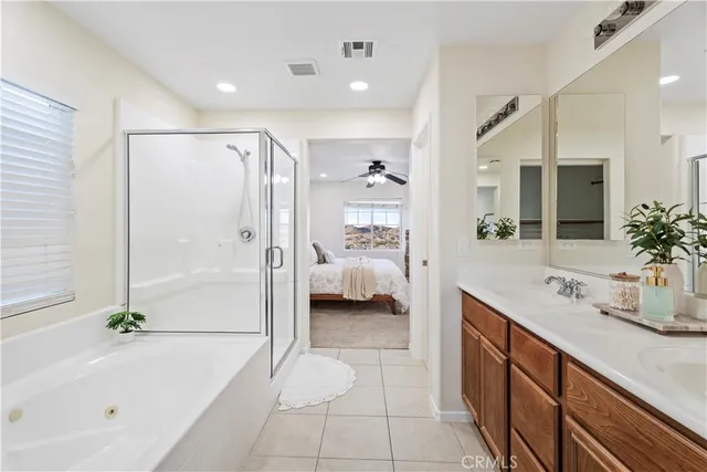 a spacious bathroom with a tub shower and sink