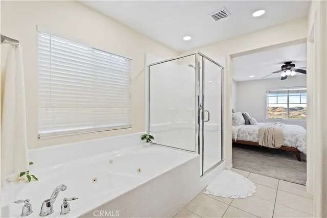 a bathroom with a tub shower and sink