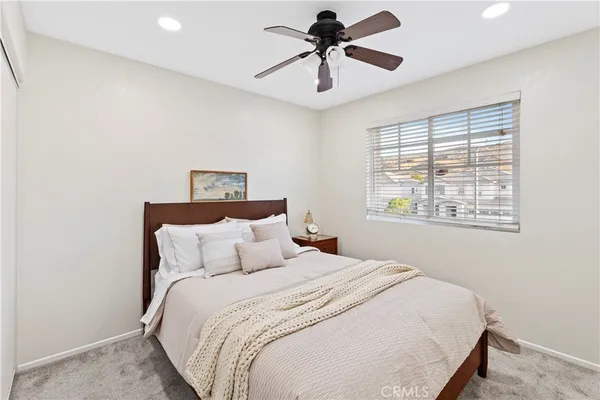 a bedroom with a large bed and a window