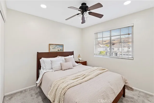 a bedroom with a large bed and a window