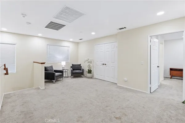 a view of a room with furniture and window