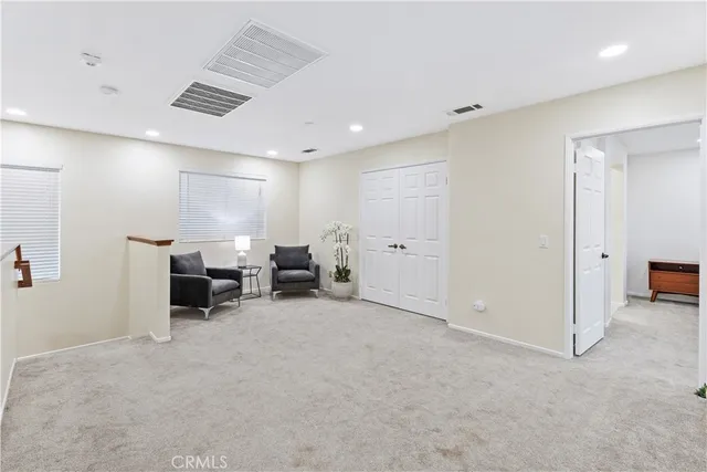 a view of a room with furniture and window