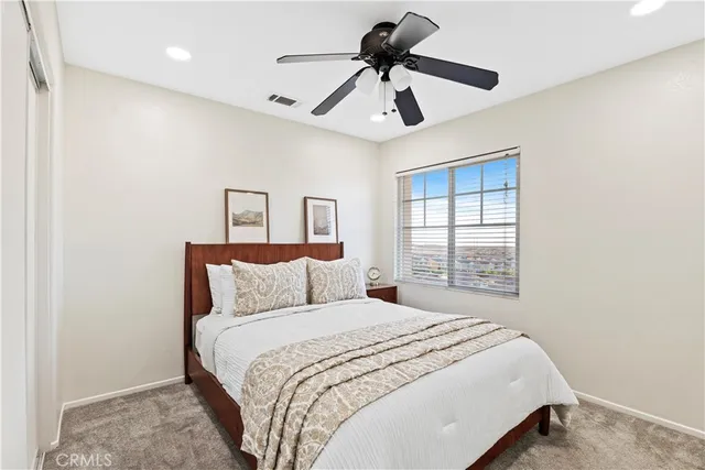 a bedroom with a large bed and a window