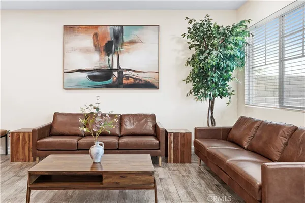 a living room with furniture and a potted plant