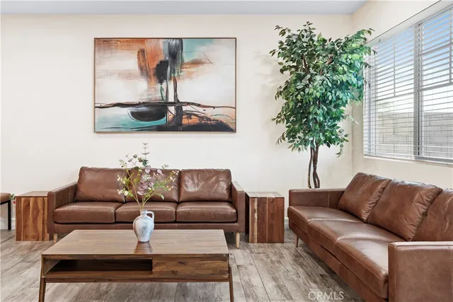 a living room with furniture and a potted plant