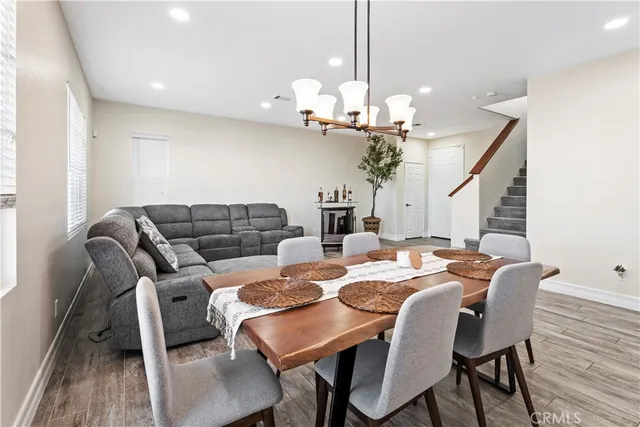 a view of a dining room with furniture wooden floor and chandelier