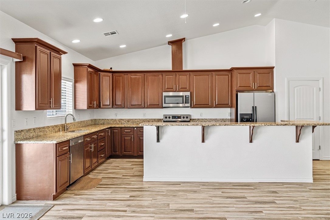 6720 Stubblefield Drive Pahrump, NV 89061 - Photo 11 of 51 A contemporary kitchen showcasing rich wood cabinetry, ample counter space, and integrated appliances.