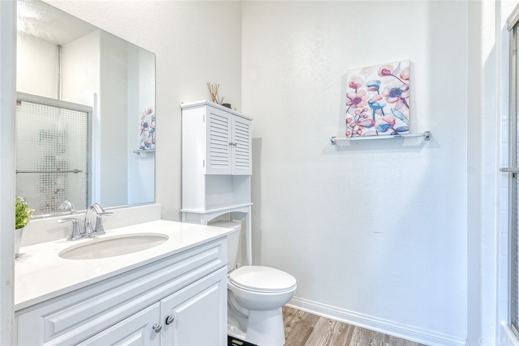 8000 Olive Lane Downey, CA 90241 - Photo 17 of 39 a bathroom with a sink a toilet and a mirror