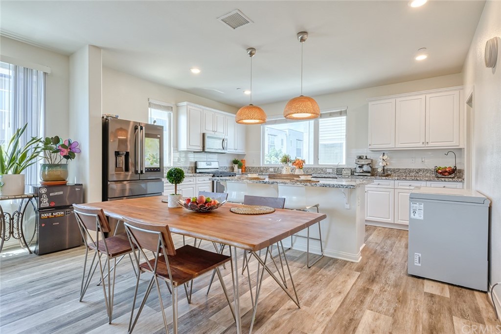 8000 Olive Lane Downey, CA 90241 - Photo 2 of 39 a kitchen with a dining table chairs and refrigerator